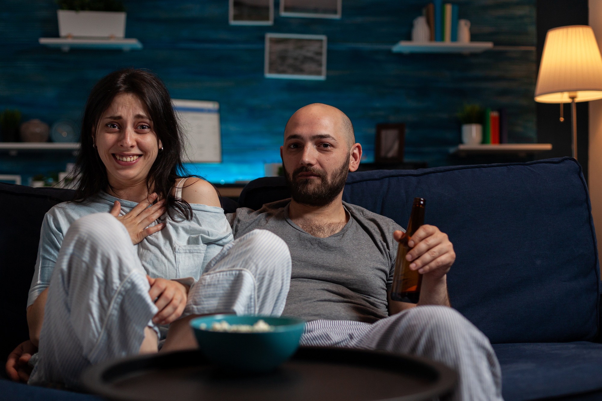 POV of girlfriend and boyfriend watching movie on TV channel